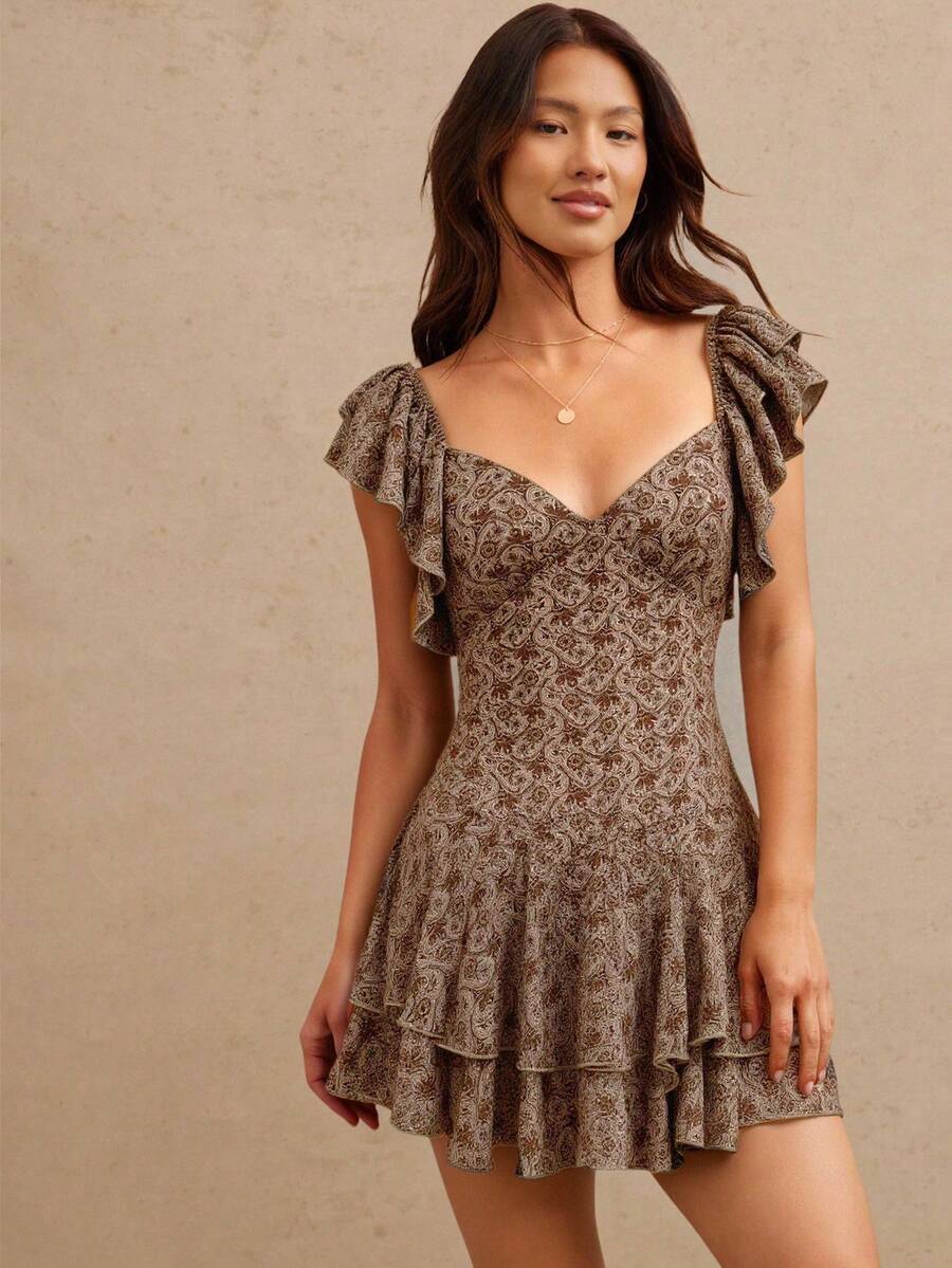 Embrace your free-spirited side with this enchanting boho mini dress! Featuring a gorgeous paisley print and flirty tiered ruffles, it's the perfect piece to turn heads this fall and winter. The relaxed silhouette offers comfort without compromising on style, while the playful details add movement and dimension to every step. Layer it with tights and boots for an effortlessly chic look that celebrates your unique vibe. Whether you're heading to a casual gathering or a night out, this dress brings that covet