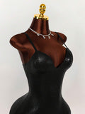 Close-up of black embossed crocodile-texture cami dress