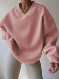 Front view of dusty pink oversized V-neck sweatshirt with balloon sleeves