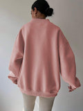 Back view of dusty pink oversized sweatshirt with longline rib-knit hem