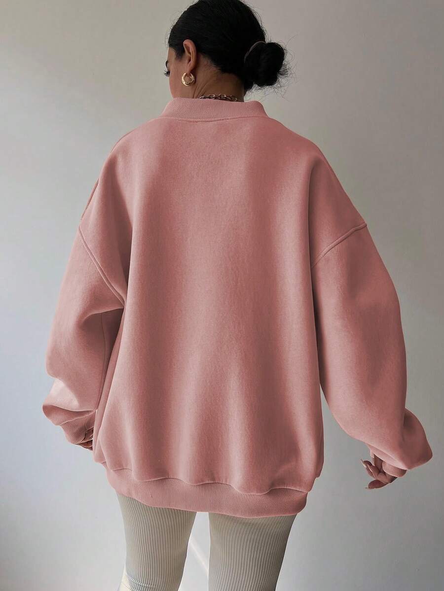 Back view of dusty pink oversized sweatshirt with longline rib-knit hem