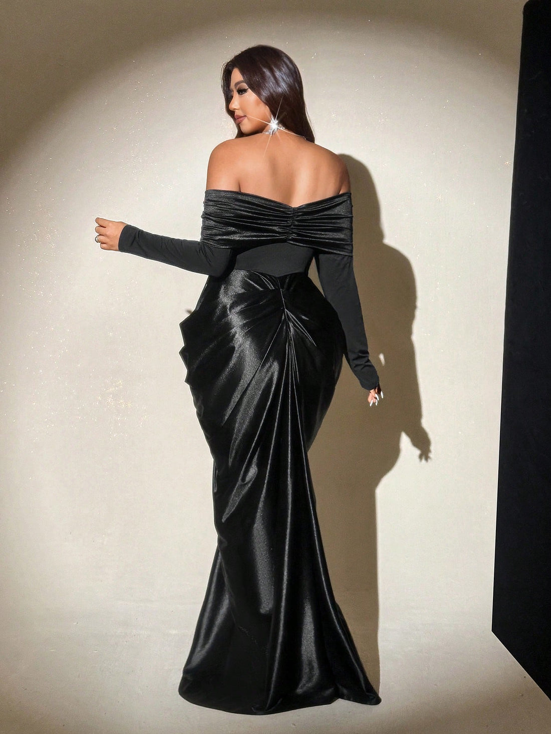 Make a statement at your next formal affair in this stunning black satin evening gown! The off-shoulder design adds a touch of timeless elegance while flattering your silhouette beautifully. Crafted from luxurious satin fabric, this plus-size gown drapes gracefully and moves with you throughout the night. Perfect for galas, weddings, or any special occasion where you want to feel absolutely fabulous. Slip into sophistication and let your confidence shine as bright as you do!