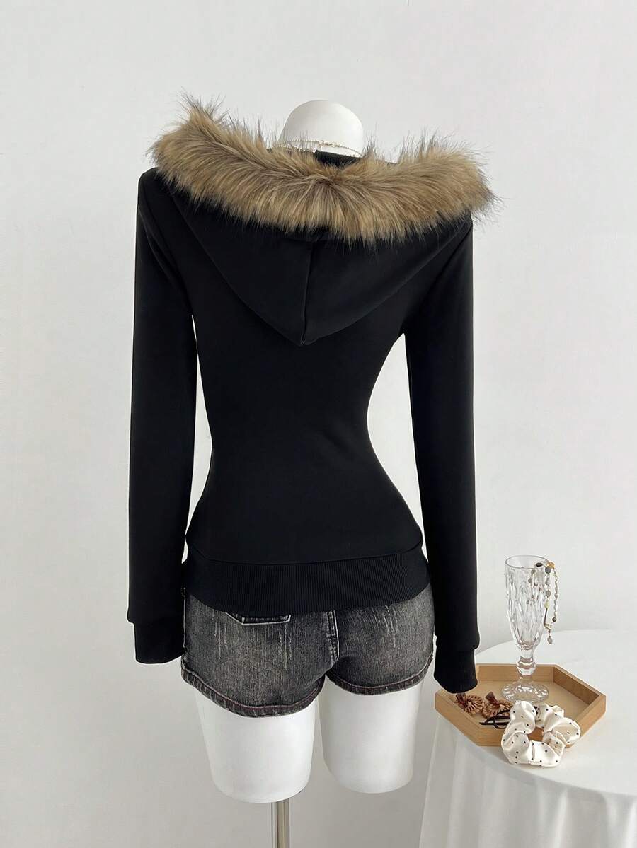 Back view of black fitted zip-up hoodie with tan faux-fur hood trim