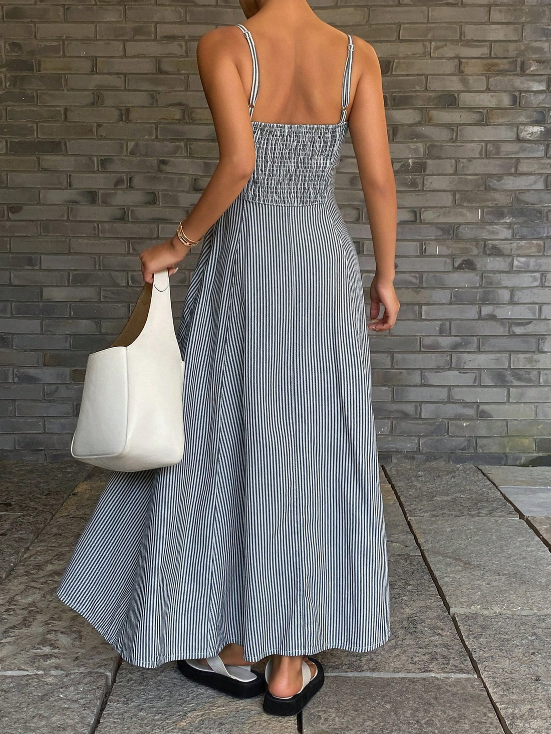 Stripes meet style in this breezy denim sundress that's basically summer in fabric form. The lightweight camisole cut keeps you cool while the classic striped pattern adds instant charm to your warm-weather wardrobe. Slip it on for effortless days at the beach, casual brunches, or whenever you want to look put-together without trying too hard. Pair it with sneakers for laid-back vibes or dress it up with sandals and jewelry for something a little fancier. This is the dress that does it all—comfortable, flat