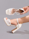 White lace platform sandal shown on foot with buckle ankle strap and chunky heel