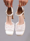 Front view of white lace platform sandals with cushioned beige insoles