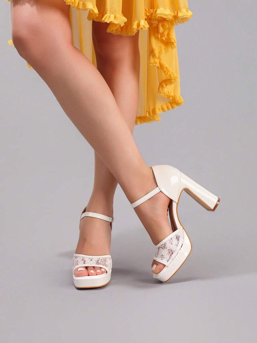 Side view of white platform sandals with glossy heel backs and ankle straps