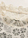 Close-up of ivory floral lace ruffled neckline and concealed zipper on plaid dress