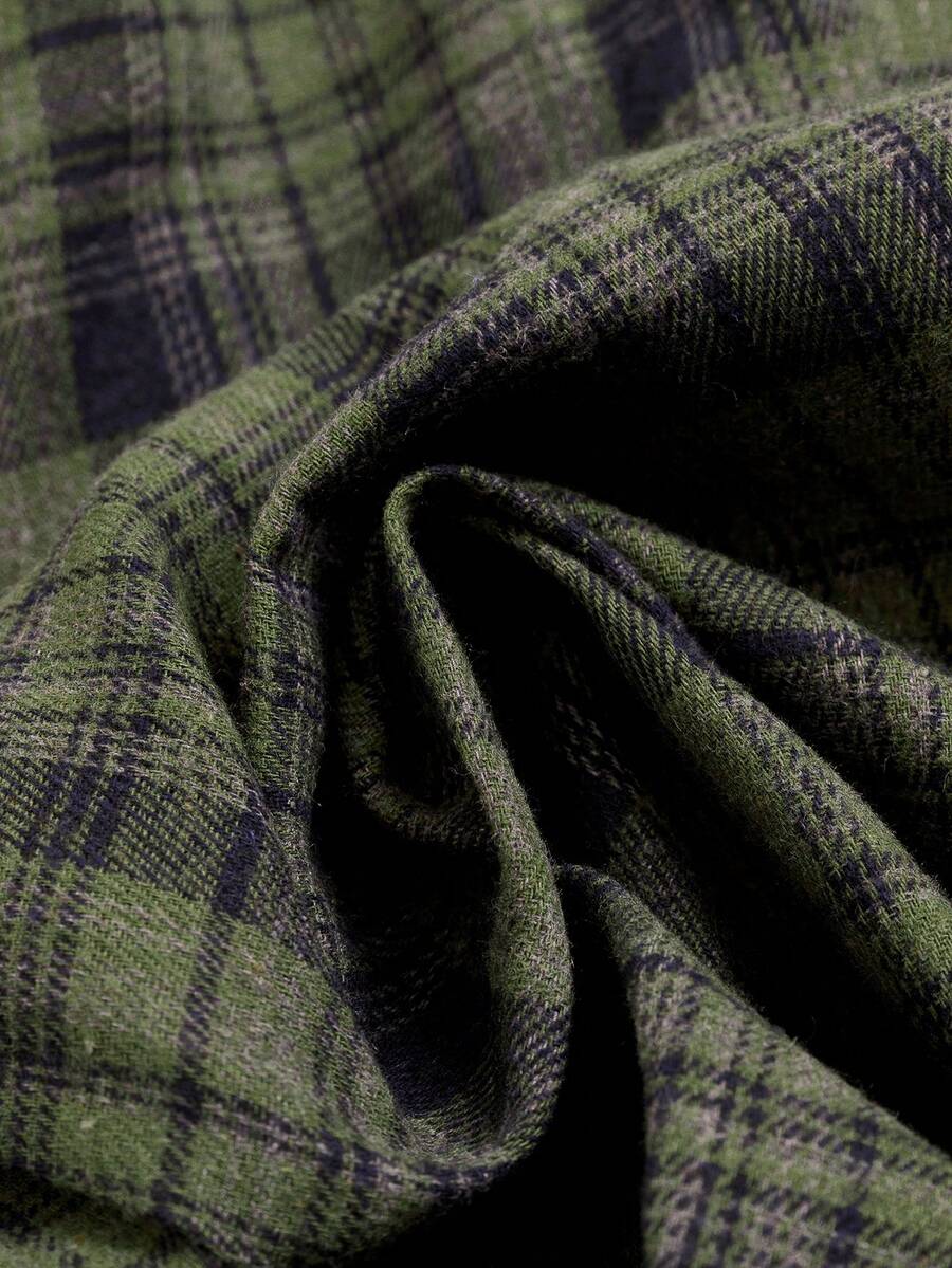 Close-up of olive green and navy tartan woven fabric on plaid A-line dress