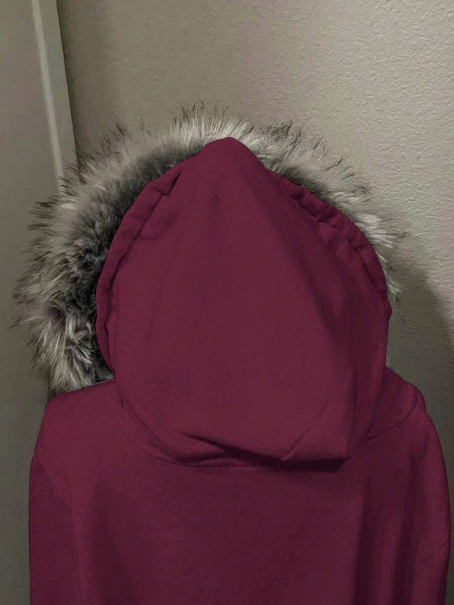 Close view of wine red jacket hood with soft grey faux-fur trim