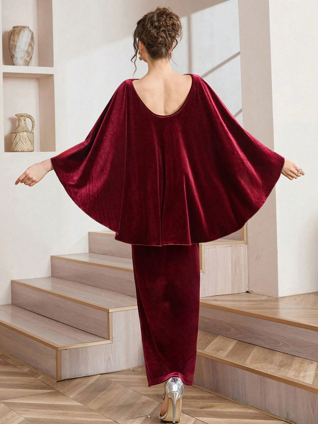 Slip into pure sophistication with this stunning wine velvet cape dress that's equal parts dramatic and wearable. The backless design flashes just enough allure while the attached shawl-style cape keeps you cozy and chic—perfect for those moments when you want to turn heads without trying too hard. Mid-length cut hits at just the right spot for effortless elegance. Whether you're heading to a special event or elevating your everyday style, this piece proves that sometimes the best outfits are the ones that 