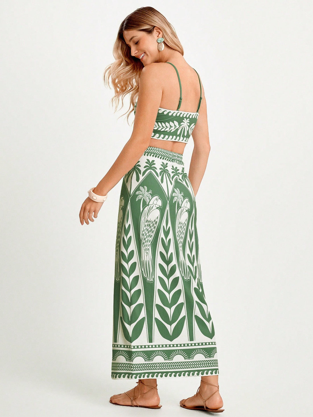 Transport yourself to paradise with this vibrant green leaf print two-piece set designed for the modern traveler. Featuring a relaxed fit and breathable fabric, this ensemble effortlessly transitions from poolside lounging to casual beachside dinners. The coordinated top and bottom create an instantly put-together look without the fuss, making it your go-to choice for tropical getaways and warm-weather adventures. Perfect for anyone who wants to embrace that carefree resort vibe, whether you're actually vac