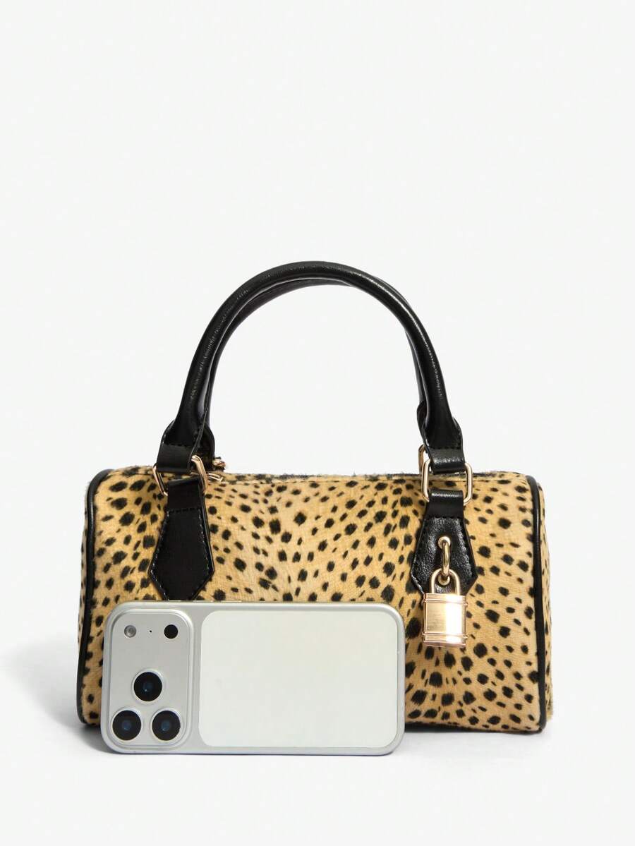 Moo-ve over, basic bags! This chic cow print top handle bag brings a playful twist to your everyday style. Featuring a striking black-and-white print that turns heads, it's paired with a gleaming golden padlock detail that adds just the right touch of vintage glamour. The structured top handle makes it perfect for everything from coffee runs to weekend adventures, while the compact silhouette keeps you looking effortlessly put-together. Whether you're channeling retro vibes or just want to add some personal