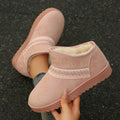 Handheld top view of pink suedette boot showing white fuzzy lining
