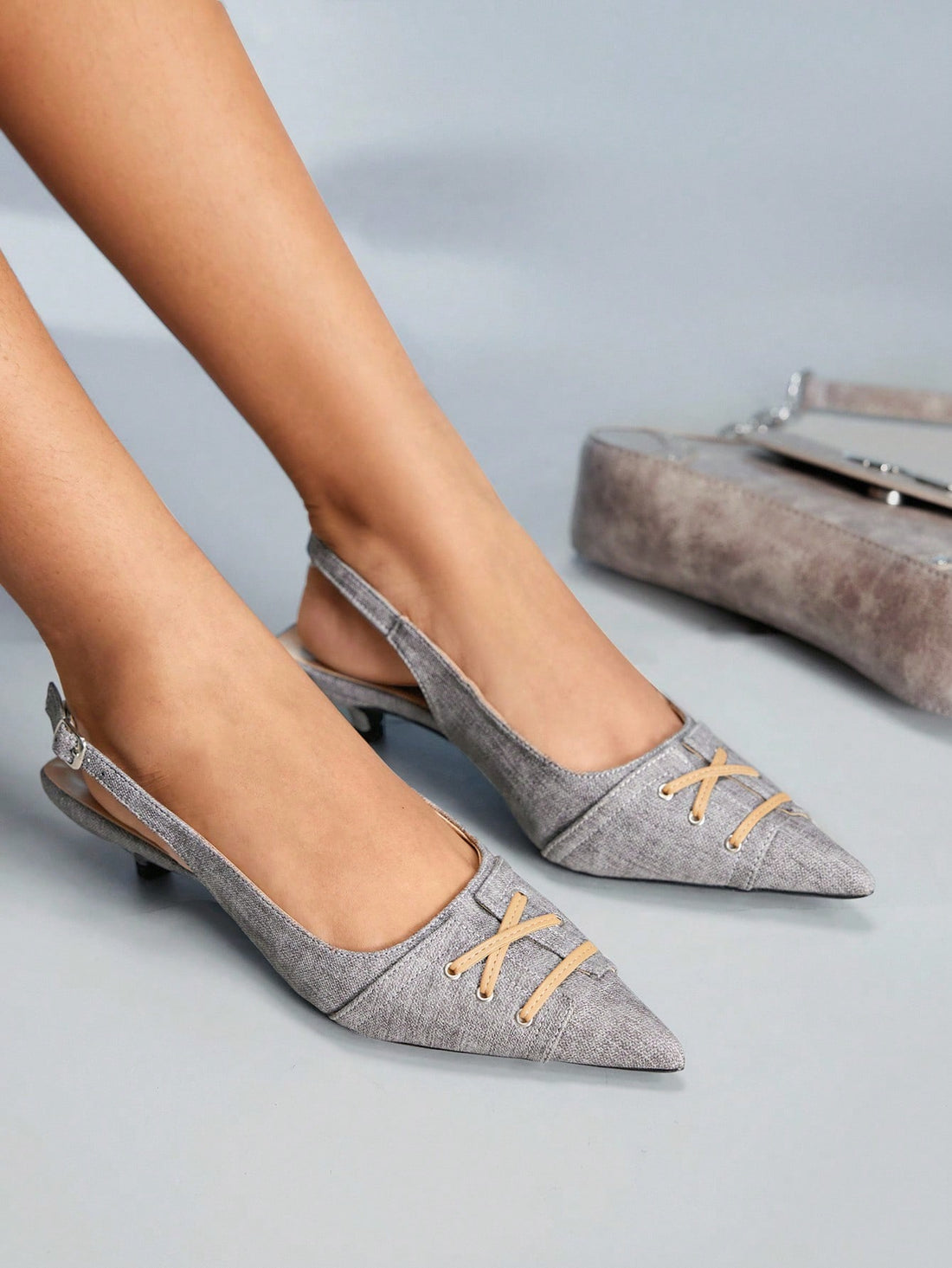 Discover refined footwear that seamlessly transitions from boardroom to evening engagements. These kitten heel pumps feature a gracefully pointed toe that flatters the foot's silhouette, paired with a stabilizing ankle strap for secure all-day wear. The understated heel height delivers professional polish without sacrificing comfort, making these pumps an intelligent choice for women who demand versatility. Their streamlined design complements an array of outfits—from professional separates to feminine dres