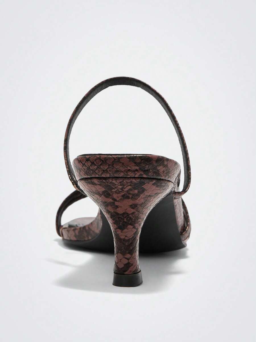 Step into sophistication with our snakeskin strapped high heel sandals—the ultimate style upgrade for any occasion. Featuring a striking snakeskin pattern and secure straps, these heels transition seamlessly from your daily commute to evening celebrations. The elevated heel adds instant glamour while the supportive design keeps you comfortable all day long. Whether you're heading to the office or dancing the night away at holiday parties, these versatile sandals deliver the perfect blend of edge and eleganc