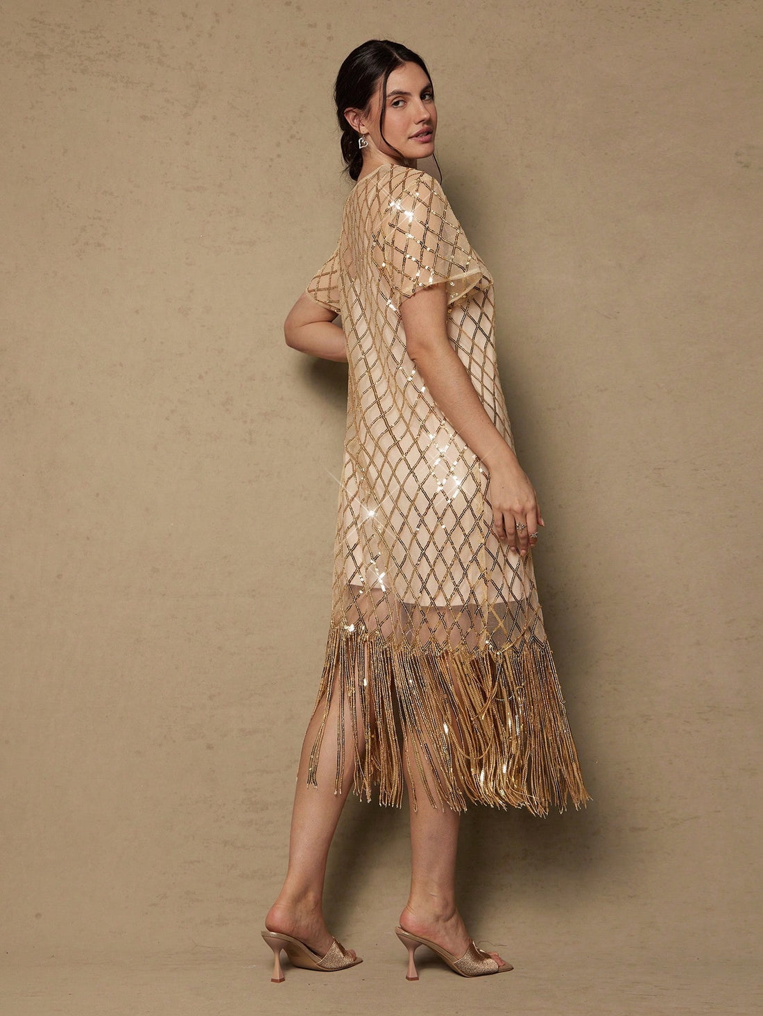 Shimmer and shine in this show-stopping plus-size sequin dress, designed for those unforgettable moments. Vintage-inspired details meet modern glamour with cascading tassels that catch the light with every twirl. Perfect for holiday celebrations, romantic evenings, or any occasion calling for extra sparkle. The flattering cut celebrates your curves while the luxe sequin fabric ensures you'll be the most dazzling guest in the room. Dress it up with heels and statement jewelry for maximum impact.