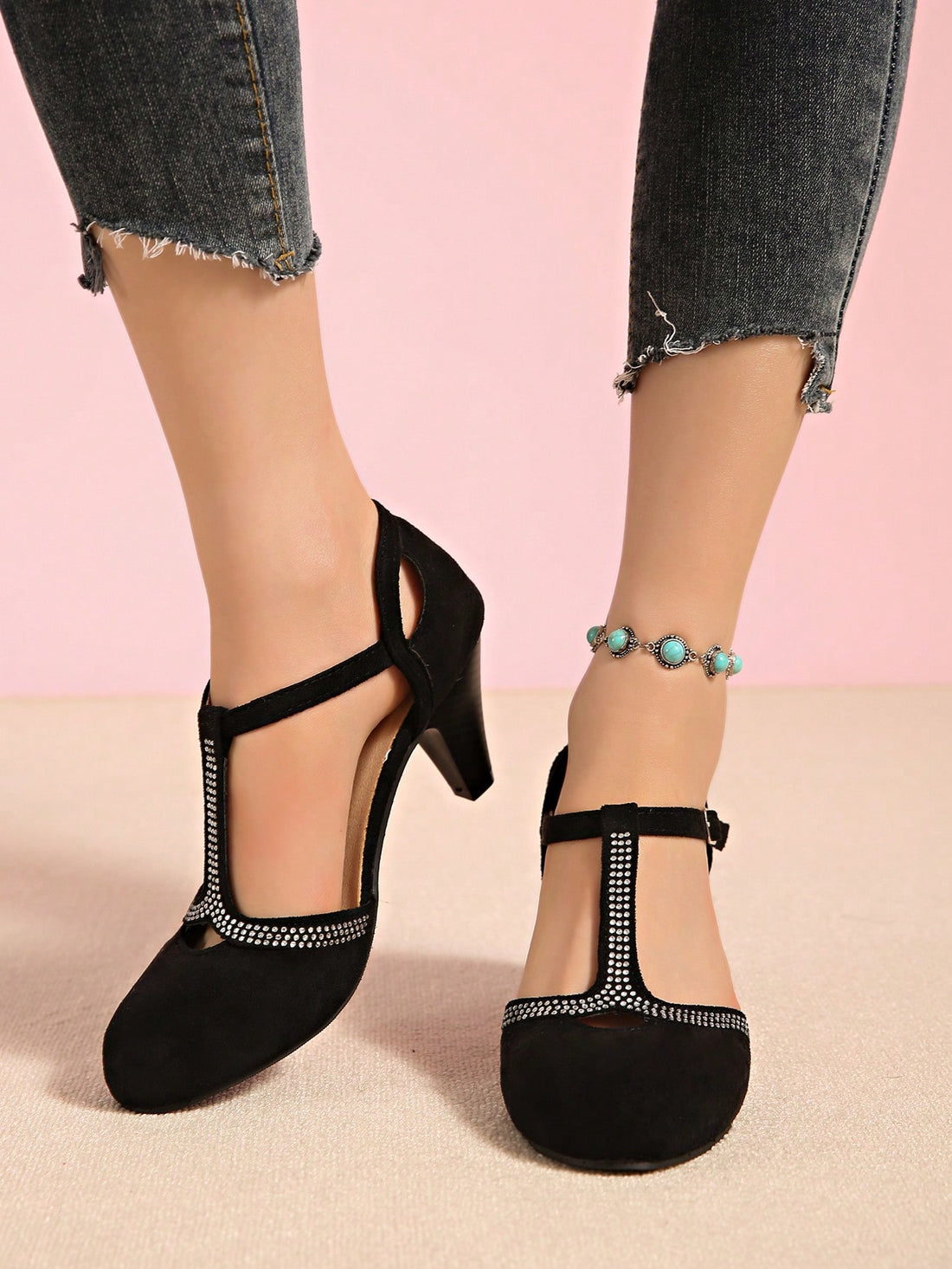 Step into sophistication with these stunning round toe high heels featuring an elegant T-strap design. The delicate hollow cutouts add a modern twist while the thin heel provides a sleek silhouette that elongates your legs. Crafted for the woman who refuses to compromise between style and wearability, these heels transition seamlessly from office to evening out. The supportive T-strap keeps your foot secure all day long, while the refined round toe offers a timeless appeal. Perfect for elevating any outfit 
