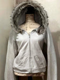 Front view of light grey hooded zip-up jacket with faux-fur trim and pockets