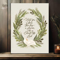 Nativity verse canvas art with green wreath and white lily on wood shelf