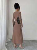 Back full view of taupe and black floral slim-fit knit midi dress with subtly flared hem