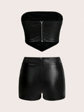 Rear flat-lay view of strapless crop top zipper and matching black short bottoms