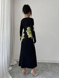 Back full view of black and pale lime floral slim-fit knit midi dress with subtly flared hem