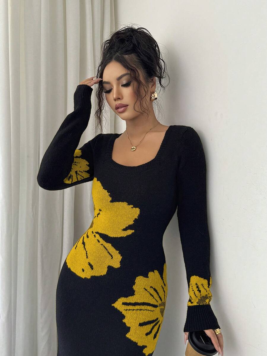 Close front view of black and mustard floral sweater dress with ribbed square neckline and cuffs