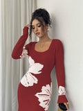 Close front view of burgundy and white floral sweater dress with ribbed square neckline and cuffs