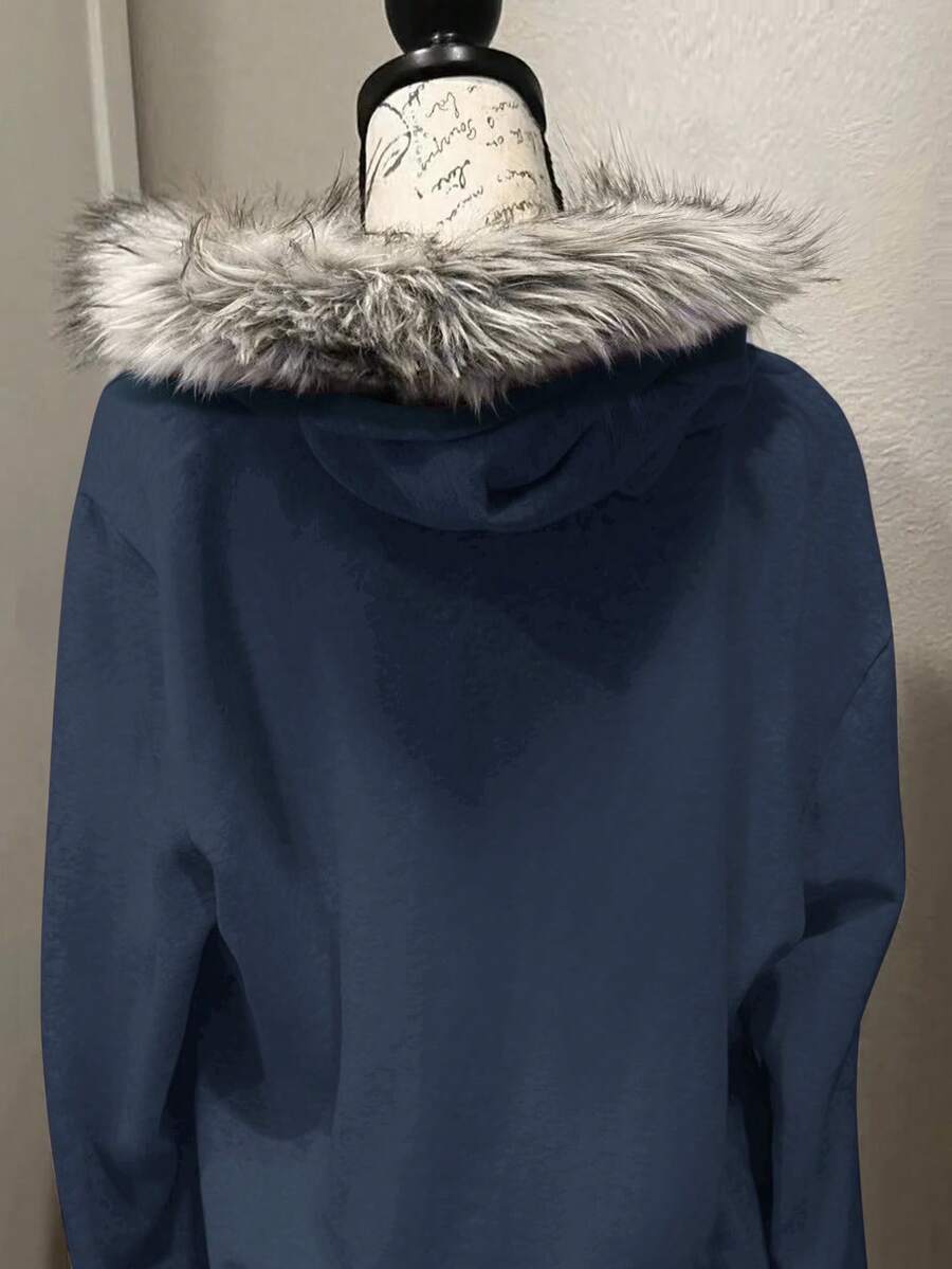 Back view of navy blue hooded zip-up jacket with faux-fur trimmed hood