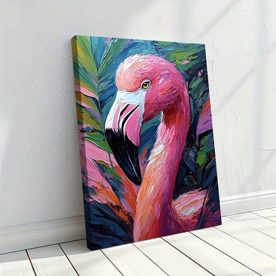 Pink flamingo canvas wall art on a tabletop beside a white vase and dried flowers