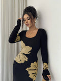 Close front view of black and beige floral sweater dress with ribbed square neckline and cuffs