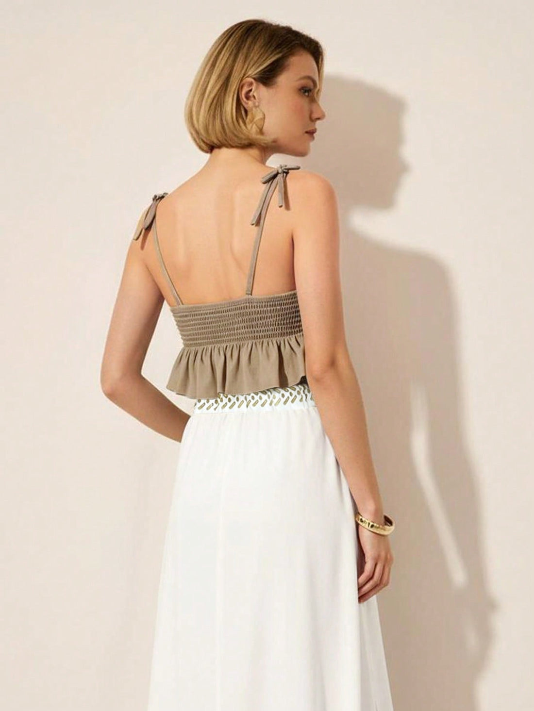 Elevate your warm-weather wardrobe with this charming two-piece set that's perfect for those carefree summer days. Featuring delicate spaghetti straps and a flirty ruffle hem, this outfit strikes the ideal balance between comfort and style. Whether you're heading to brunch, a beach getaway, or a casual night out, this versatile ensemble keeps you looking effortlessly put-together. The lightweight fabric moves with you, while the playful ruffle details add just the right amount of personality. Dress it up wi