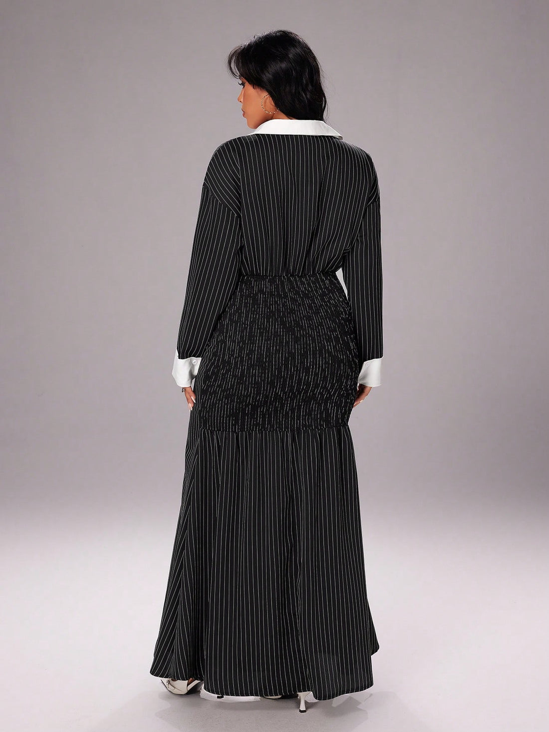 Stripes never go out of style—and this sleek midi dress proves it! Featuring a crisp shirt collar and a flattering bodycon silhouette, it's the kind of piece that works overtime in your wardrobe. Dress it up with heels and jewelry for a night out, or keep it casual with sneakers and a denim jacket. The timeless black and white combo means it pairs with practically everything, making it your new go-to for any season. Effortless elegance that actually feels fun to wear.