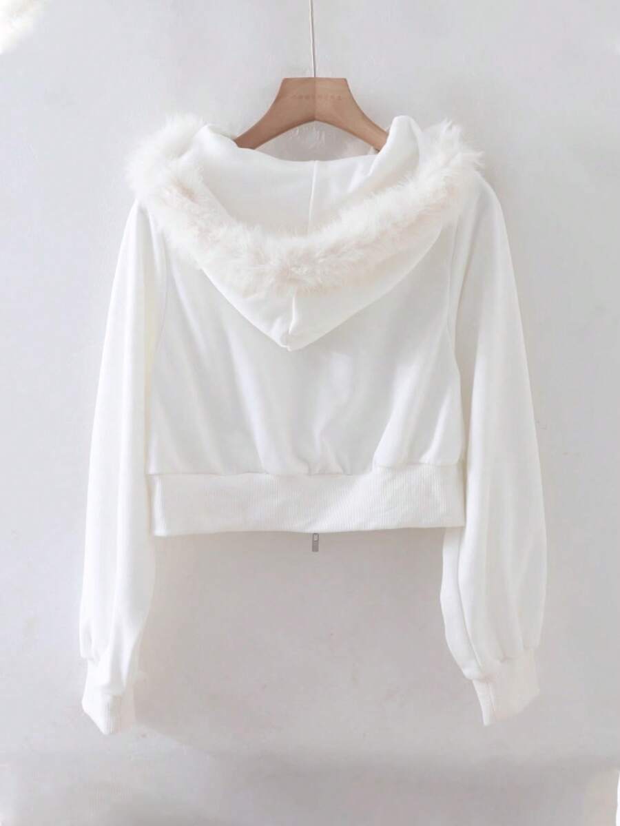 Back view of white hooded zip-up jacket with faux-fur trim and cropped styling