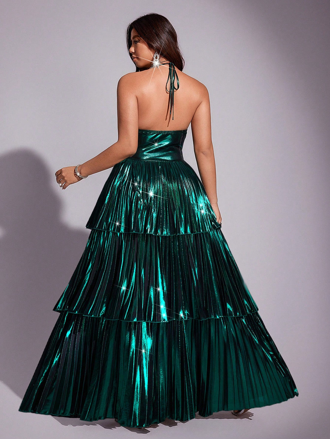 Shine bright like the star you are in this stunning metallic pleated dress! Designed for curves and celebration, this halter-neck beauty features eye-catching shimmer and elegant pleating that flatters your silhouette from every angle. Perfect for parties, galas, or any moment worth dressing up for, this plus-size showstopper combines comfort with glamour. The halter neckline adds a touch of sophistication while the metallic finish catches the light beautifully. Whether you're dancing the night away or maki