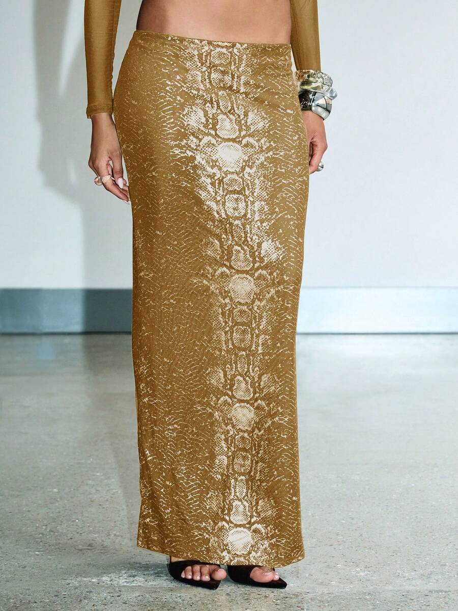 Slither into sophistication with this show-stopping snake print maxi skirt set! Featuring a mesmerizing metallic finish that catches the light just right, this piece is your ticket to turning heads at any evening soirée. The flowing maxi silhouette offers effortless elegance while the bold snake pattern adds just the right amount of edge. Perfect for fall and winter gatherings, this set combines drama with wearability—because who says you can't be both fierce and fabulous? Dress it up with heels and stateme