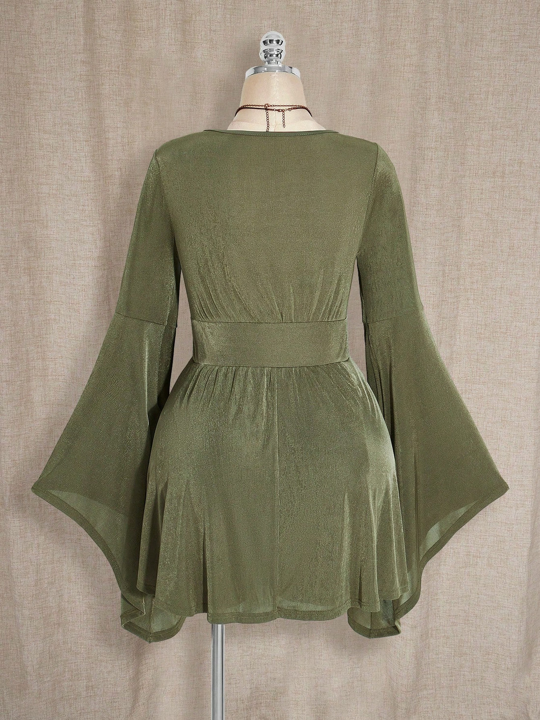 Embrace your inner forest fairy with this enchanting boho Y2K dress that celebrates curves and vintage vibes. The rich military green hue evokes earthy, mystical energy, while the flattering A-line silhouette skims beautifully over the body. Fluttery flare sleeves add a whimsical touch, and the V-neckline creates an elegant focal point. Perfectly sized for plus figures, this dress transitions seamlessly from cozy autumn gatherings to magical evening adventures. Mix it with your favorite vintage accessories 