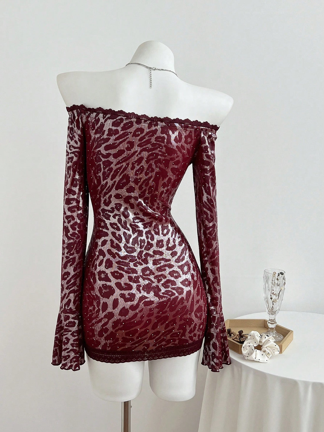 Turn heads at your next soirée in this show-stopping mini dress that perfectly blends wild and refined. The off-shoulder neckline frames your shoulders beautifully, while the leopard print adds a daring edge that's totally on-trend. Delicate lace patchwork and sparkling rhinestones elevate the look from casual to cocktail-ready in seconds. Whether you're hitting a party or making a grand entrance at an event, this dress delivers major style points without taking itself too seriously. It's the kind of piece 