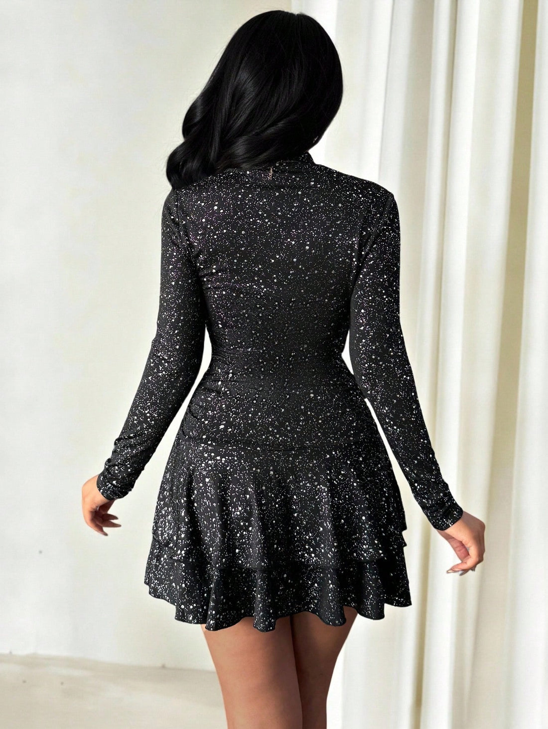This sophisticated mini dress combines timeless elegance with contemporary flair. Crafted from shimmering sequin fabric in a rich black metallic finish, it features a classic turtleneck that provides refined coverage while the playful ruffle hem adds movement and dimension. Perfect for evening celebrations or elevated daytime occasions, this versatile piece transitions seamlessly from autumn gatherings to winter events. The structured silhouette flatters while the luxe sequin detailing catches light beautif