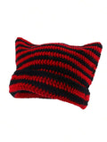 Red and black striped crochet knit beanie folded flat with thick yarn texture