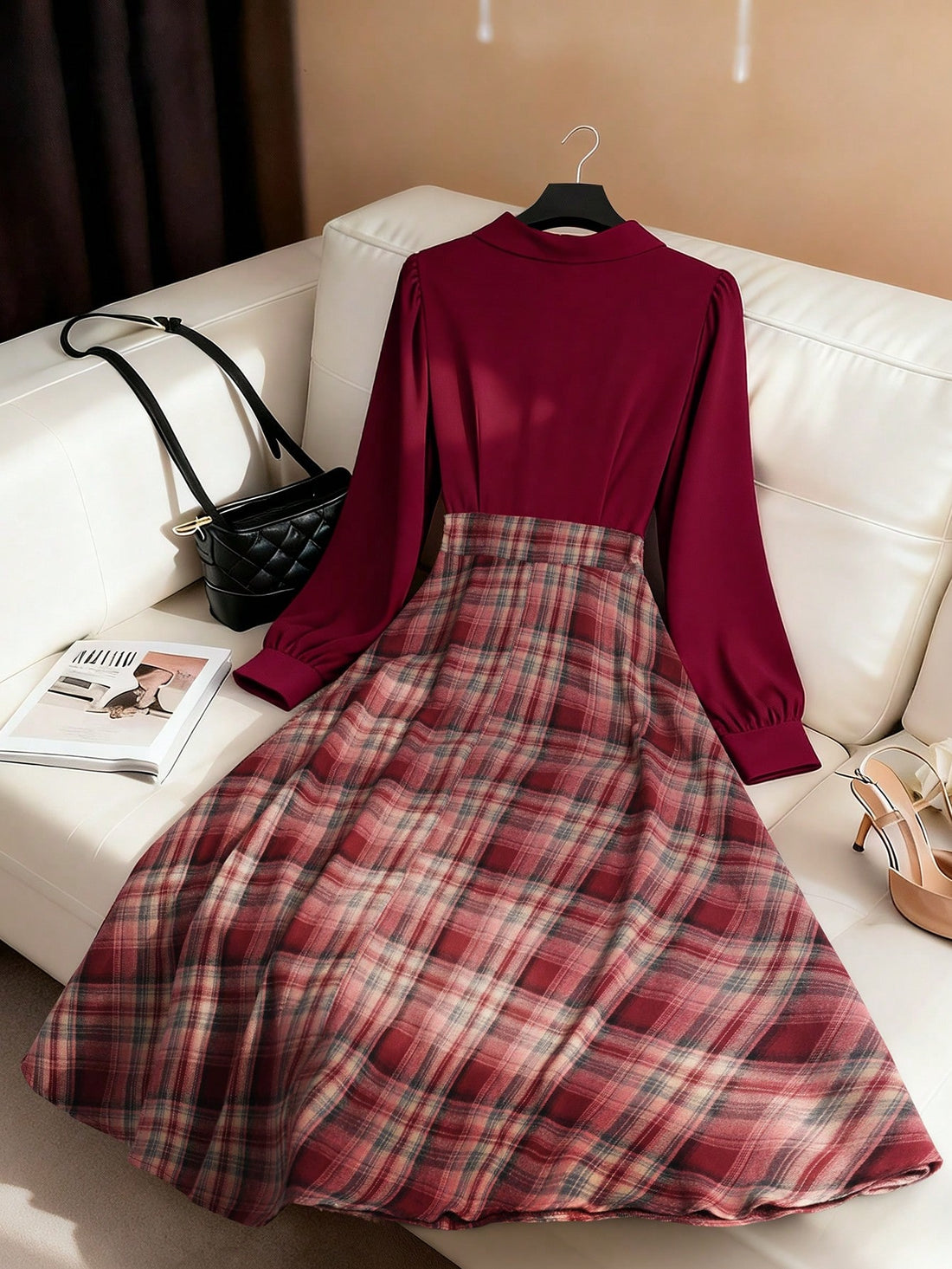 Crafted from a refined burgundy plaid fabric, this A-line dress combines timeless sophistication with versatile styling. The flattering silhouette skims the body gracefully, creating an elongating effect that works beautifully for various occasions. Whether styled casually for everyday wear or dressed up for holiday celebrations, this piece transitions seamlessly between seasons and settings. The classic plaid pattern adds visual interest while maintaining an understated elegance, making it a reliable found
