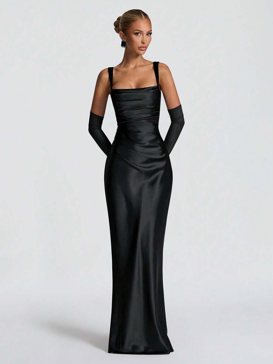 Front view of olive satin mermaid gown styled in a lounge with evening decor