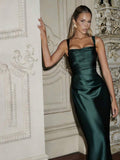 Front three-quarter view of dark teal satin gown with square neck and fitted waist