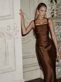 Front view of brown satin-look fitted evening gown with square neck, slim straps and ruched bust