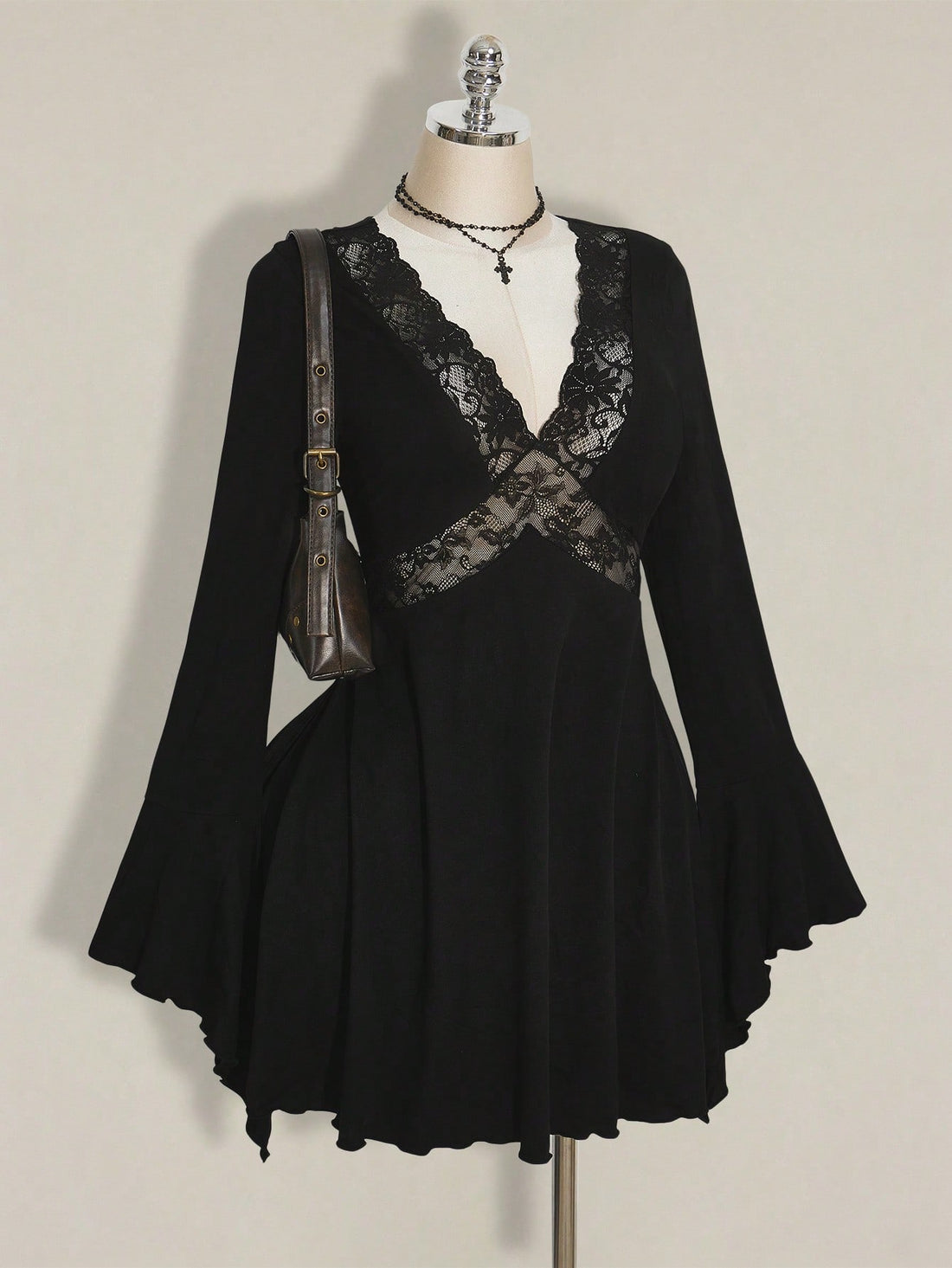 Make a statement this season in a dress that's equal parts sophisticated and fun. This elegant plus-size number features a flattering V-neckline and romantic flared sleeves adorned with delicate lace trim that catches the light beautifully. The classic black silhouette works overtime—dress it up for holiday parties or down for autumn gatherings. Designed to celebrate curves with confidence, it's the versatile piece your wardrobe has been waiting for. Perfect for anyone who refuses to compromise on style or 