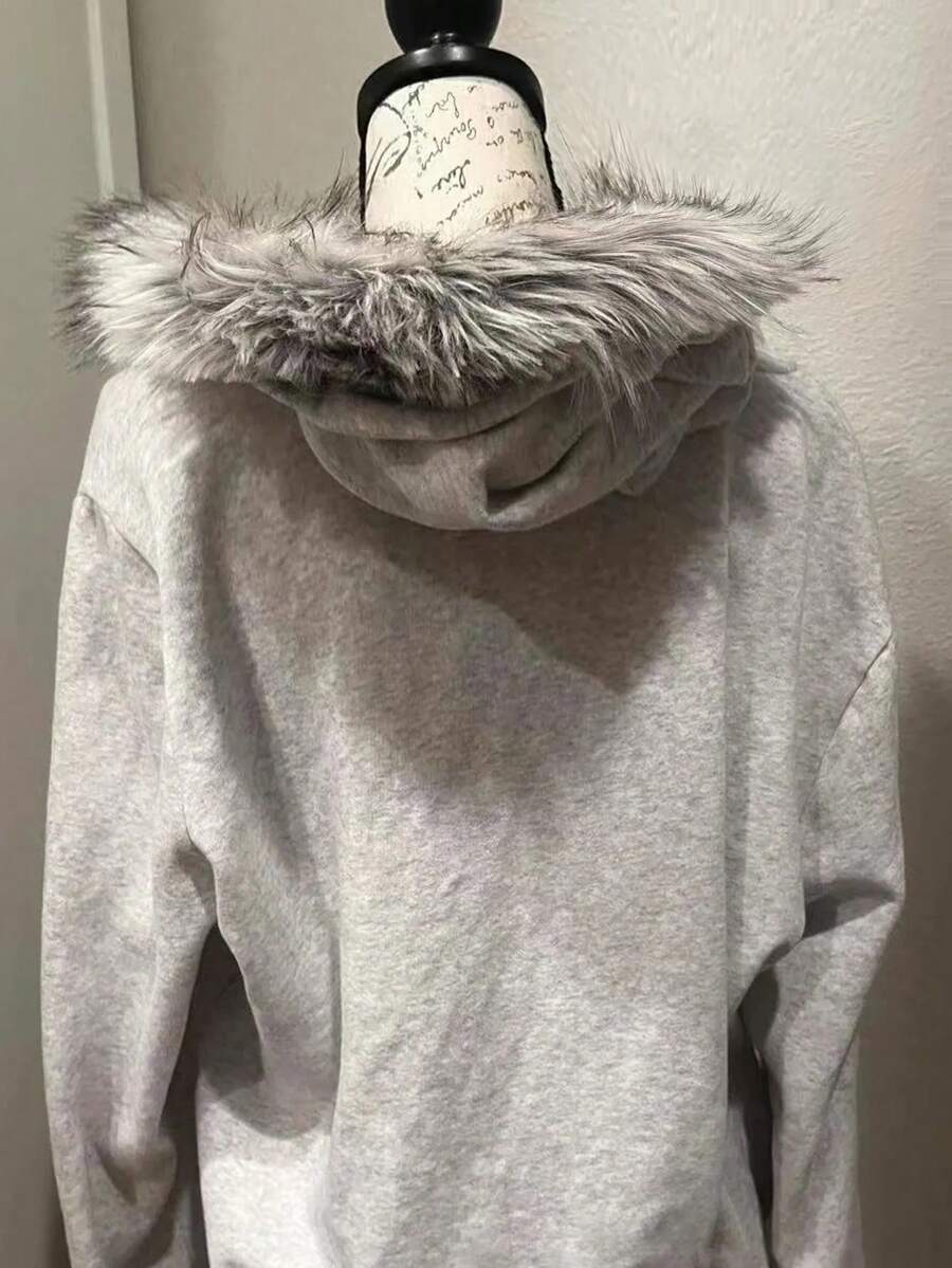 Back view of light grey graphic hooded zip-up jacket with faux-fur trimmed hood