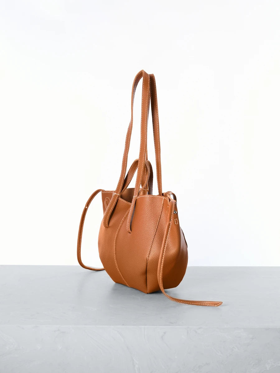 Elevate your everyday style with this chic Korean-inspired lychee texture pleated shoulder bag. Crafted from durable polyurethane, this large-capacity tote features a sophisticated brown finish and distinctive spiked details for an edgy-elegant aesthetic. The double-handle design and no-closure silhouette offer effortless accessibility, making it perfect for shopping trips and casual outings. Its vintage-inspired bucket shape combines practicality with contemporary fashion sensibility, delivering a versatil