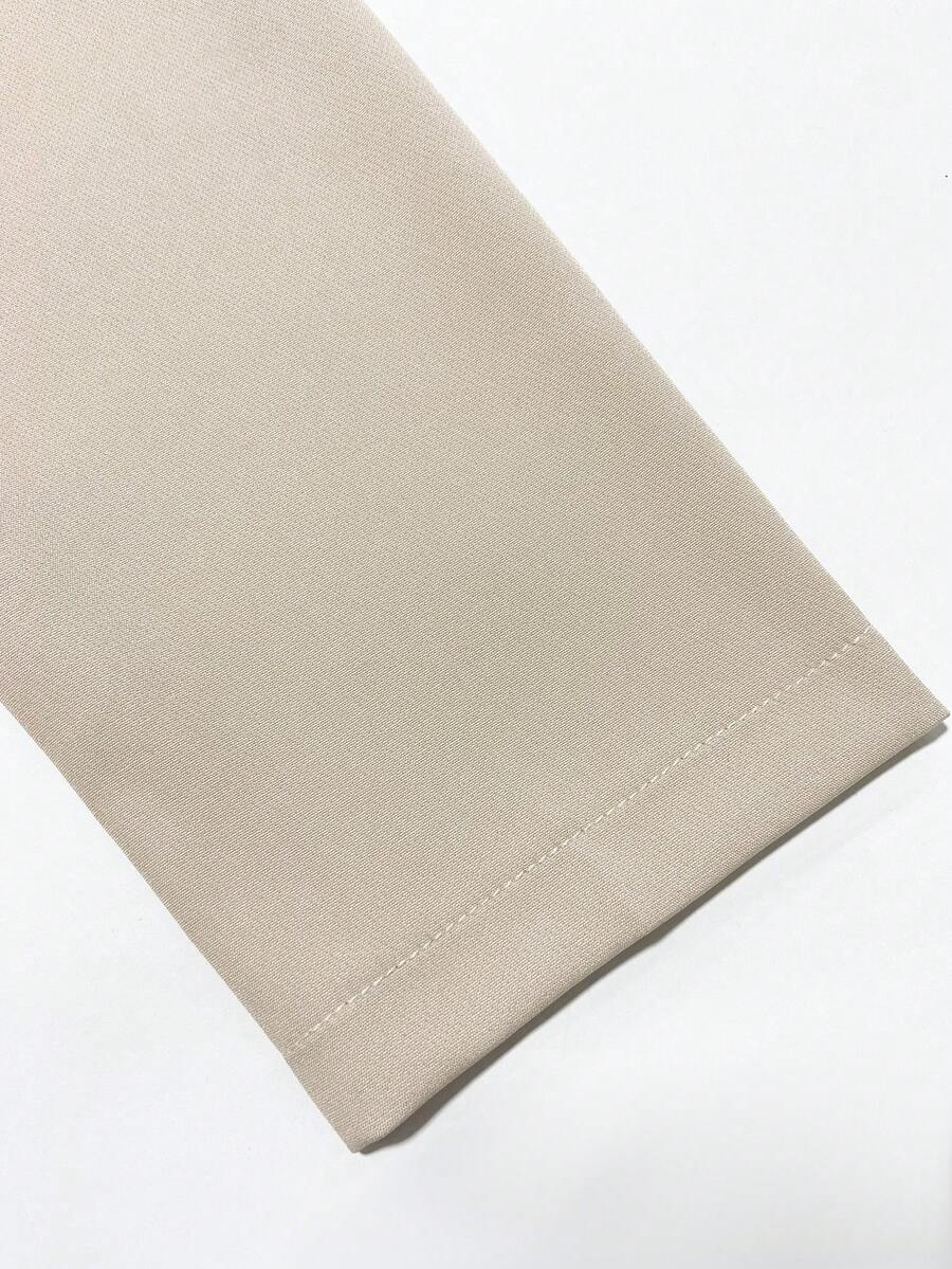 Sleeve Cuff Close-Up of ivory blazer-style midi dress with black piping for formal work styling