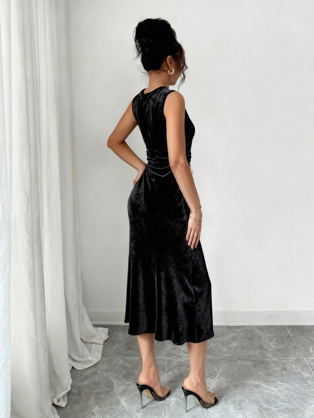 Slip into sophistication with this stunning black velvet sleeveless dress that's ready for anything your calendar throws at it. The luxe velvet fabric drapes beautifully while delicate lace trim adds a touch of refined charm. Whether you're commanding the boardroom, lounging on vacation, or turning heads at a gala, this versatile piece transitions seamlessly from day to night. The sleeveless silhouette keeps things modern and chic, while the timeless black hue pairs effortlessly with your favorite accessori